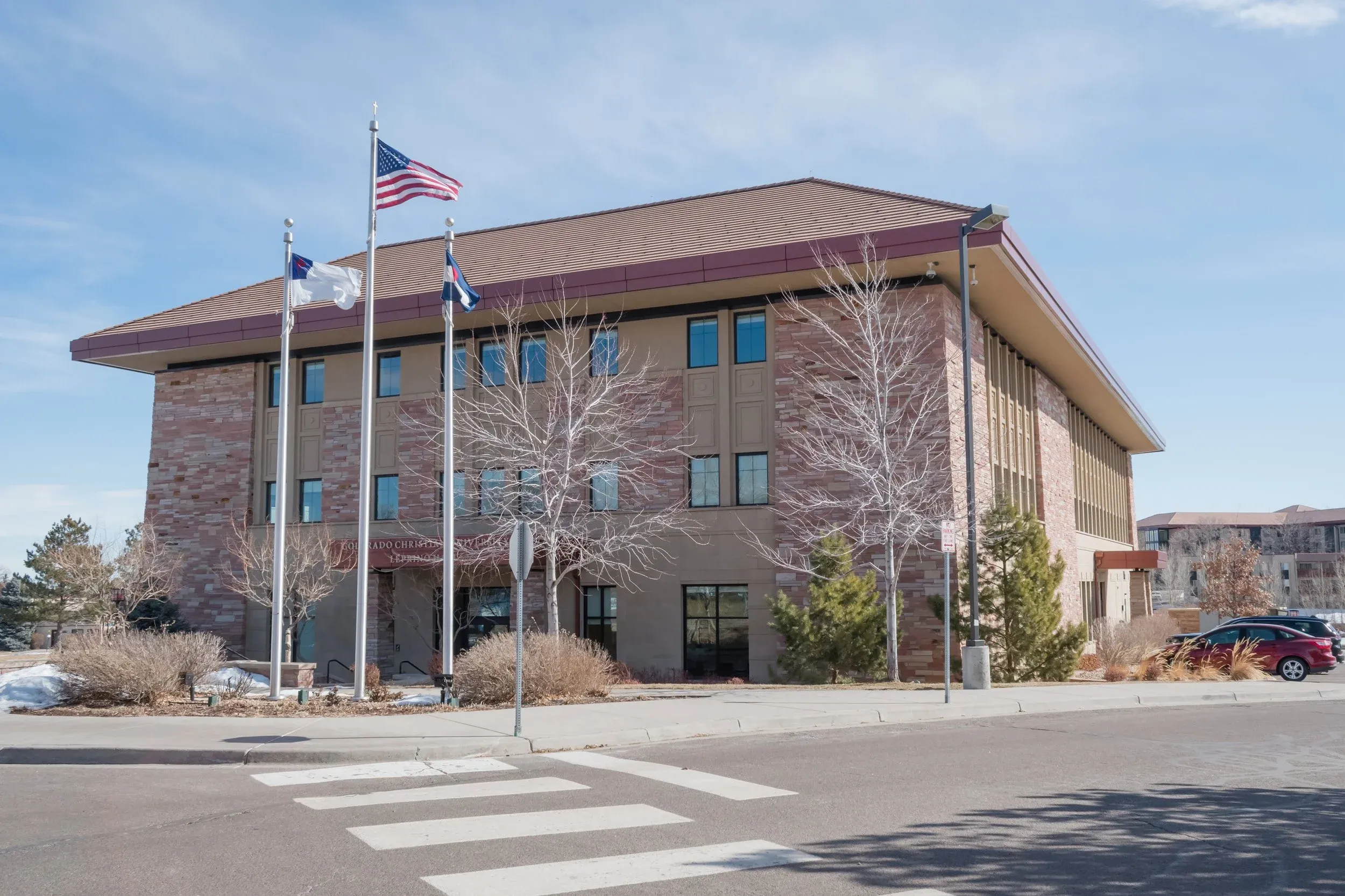 Leprino Hall on the Colorado Christian University campus, with flags out front